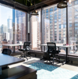 Gold Coast office with two desks and floor to ceiling windows overlooking the city