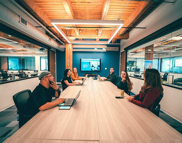 people sitting in a conference room and discussing