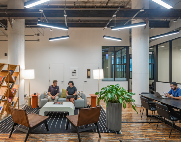group of people sitting and working around a office