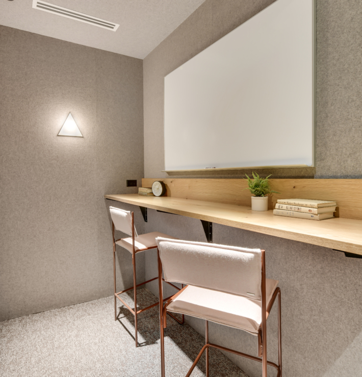 couple of white chairs sitting under a white board at downtown