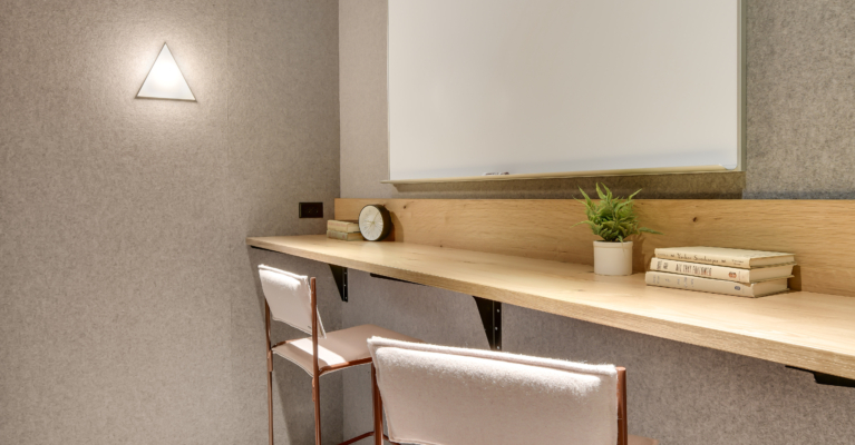 couple of white chairs sitting under a white board at downtown