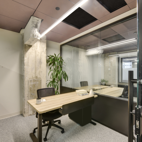 office cubicle with a desk and chair in the workbox down town