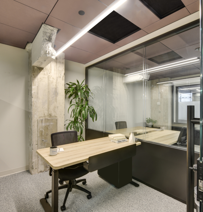 office cubicle with a desk and chair in the workbox down town