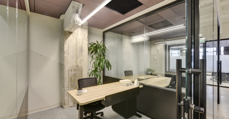 office cubicle with a desk and chair in the workbox down town