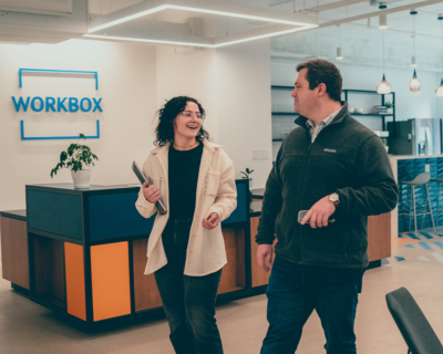 man and a woman talking near workbox reception