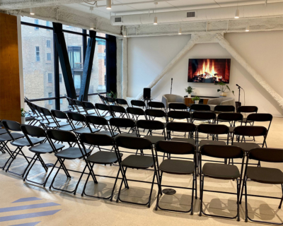 event space filled with lots of chairs and a projector