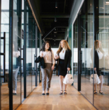 working womens walking and talking in office