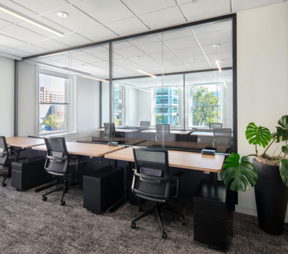 desks with chairs near a large office window