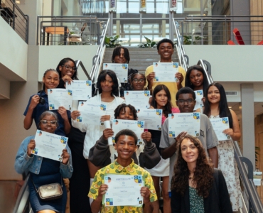 Proud group of children displaying their certificates